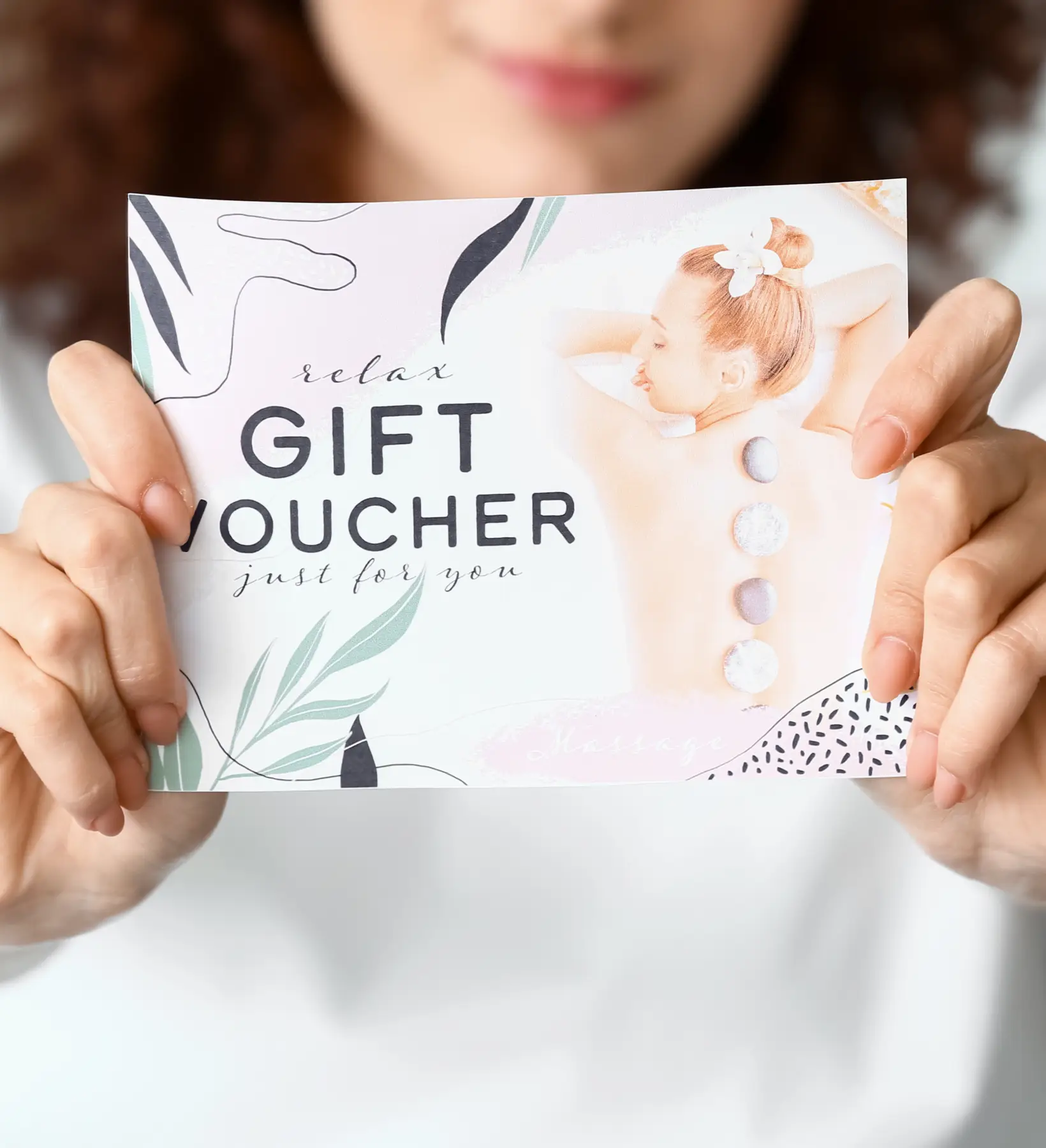 Woman holding a Green Dragon Massage gift card voucher